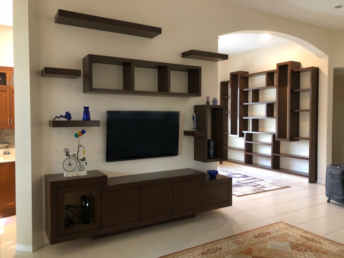 Living room with floating shelves and TV wall unit